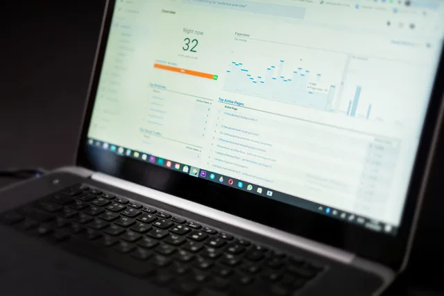 A laptop displaying an analytics dashboard with real-time data tracking and analysis tools. A professional services marketing reporting dashboard works only if it drives decisions